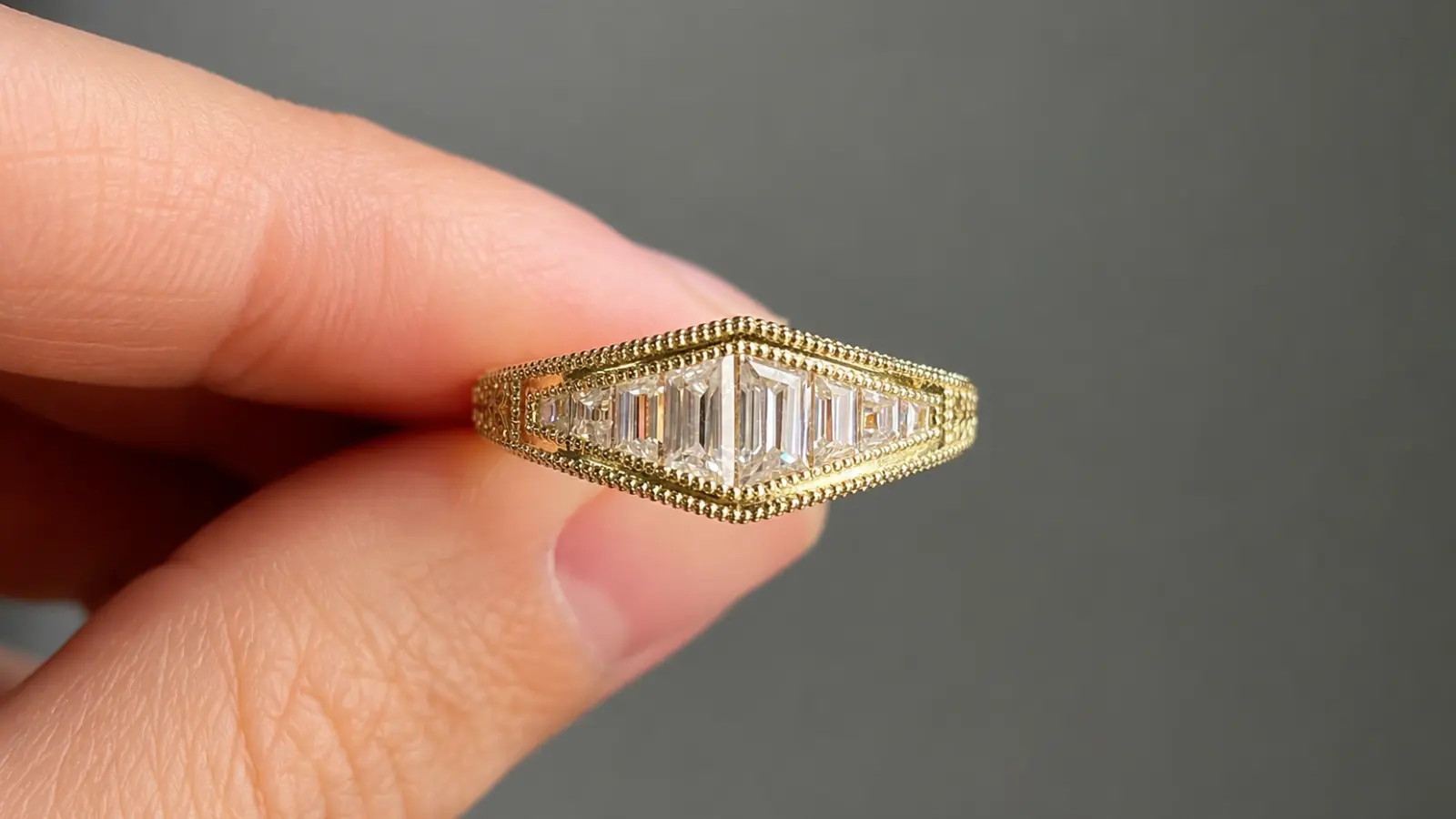 A close-up of a geometric Art Deco diamond ring featuring baguette-cut diamonds, fine milgrain edges and symmetrical vintage styling Art Deco Wedding Rings