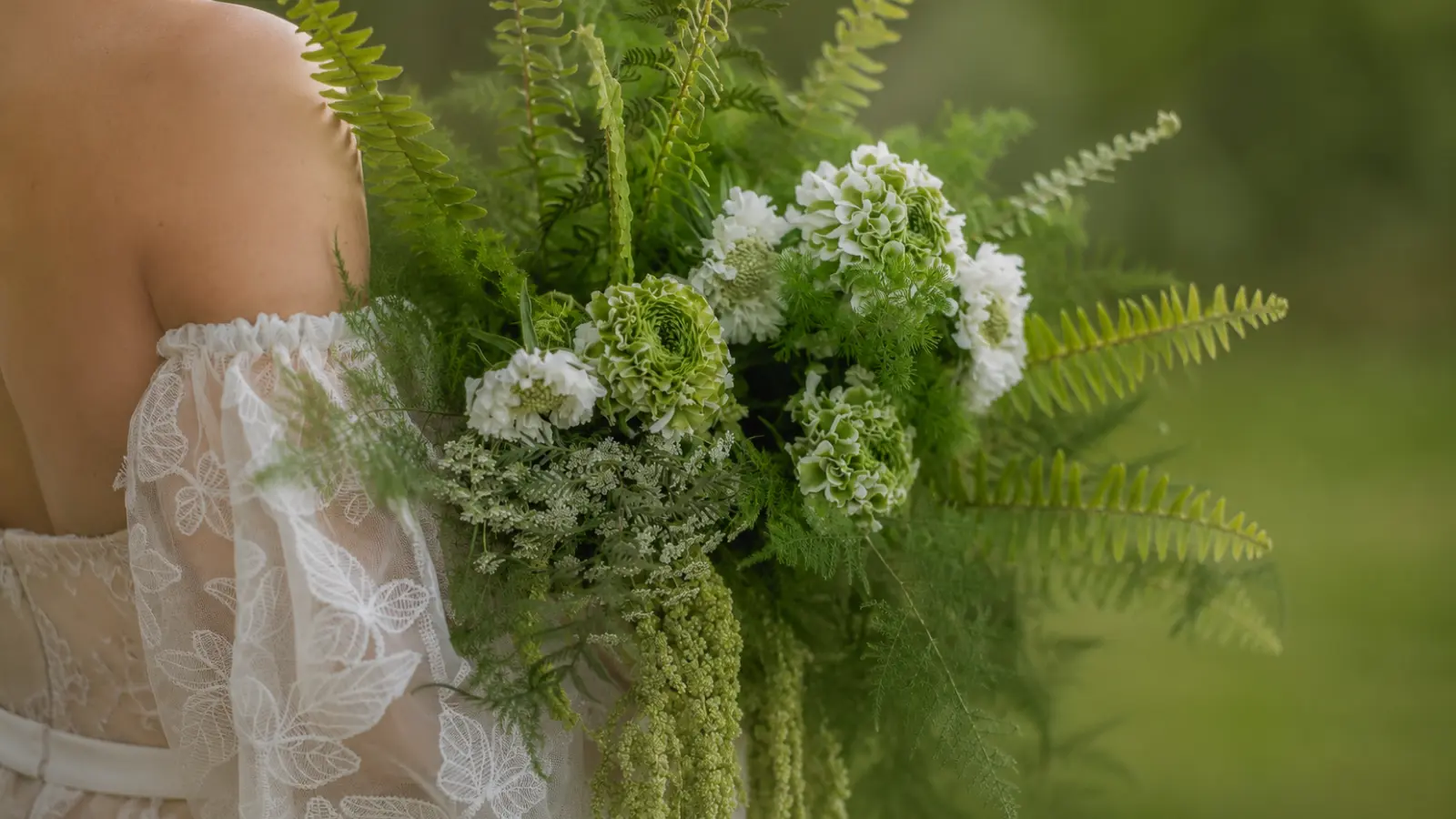 Modern greenery wedding bouquet featuring lush ferns textured foliage and soft green flowers in an organic design
