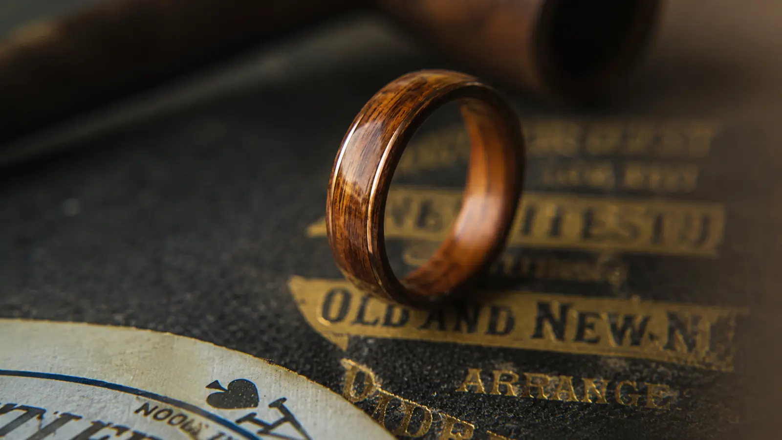 A handcrafted wood wedding ring stands upright, showcasing its natural wood grain, polished finish and distinctive organic character