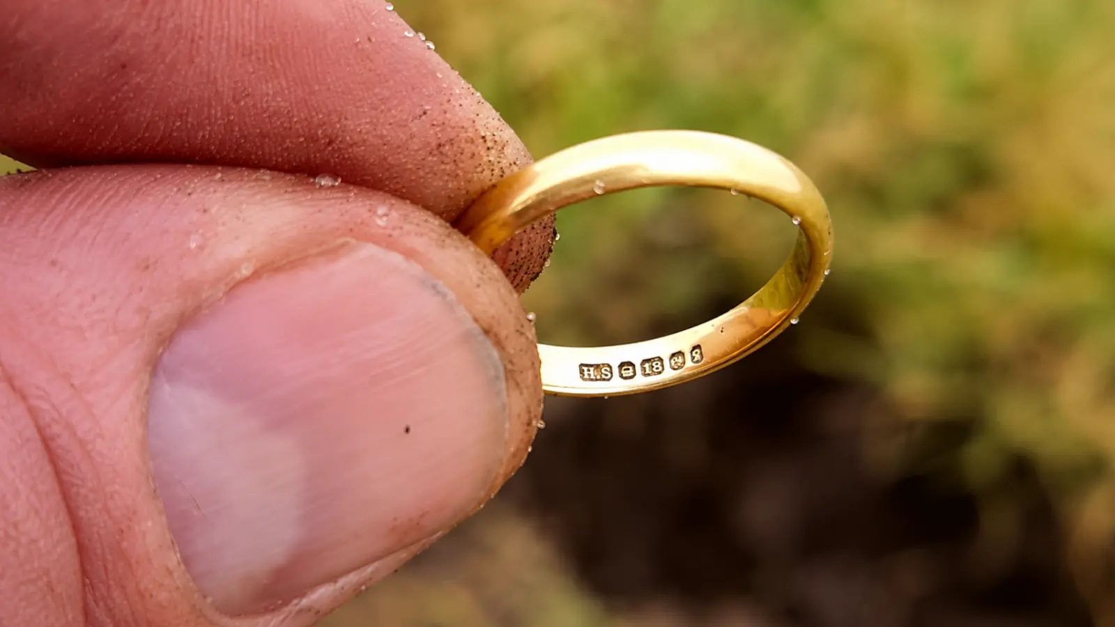 Close-up of a recovered gold wedding ring showing hallmarks that can help identify its owner