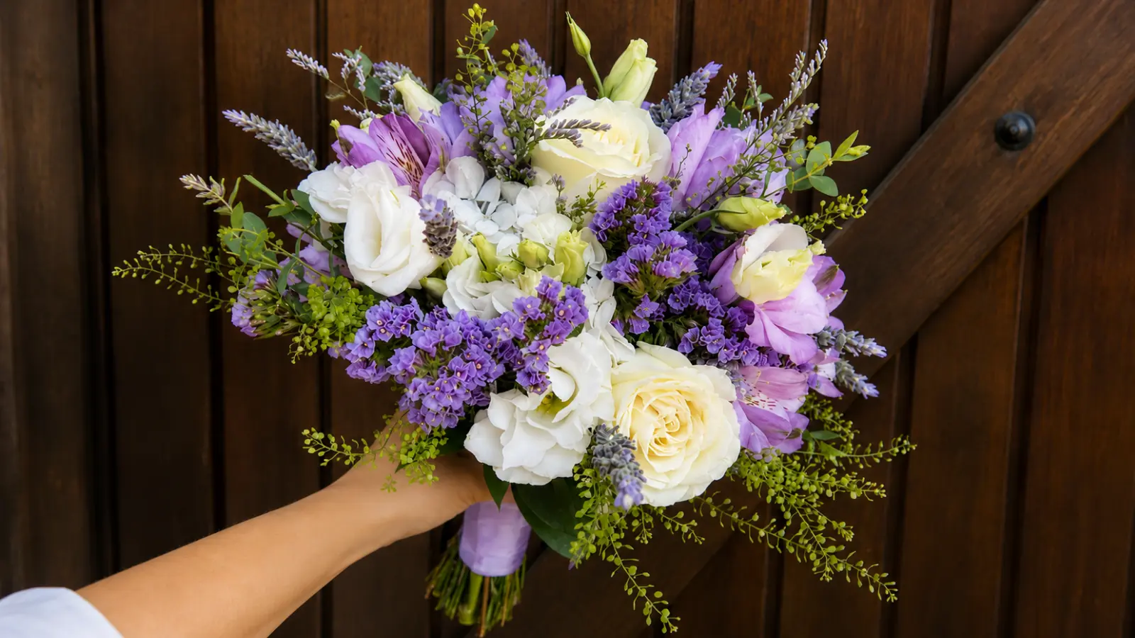 Lavender and white wedding bouquet with roses, lisianthus, lavender and seasonal garden flowers
