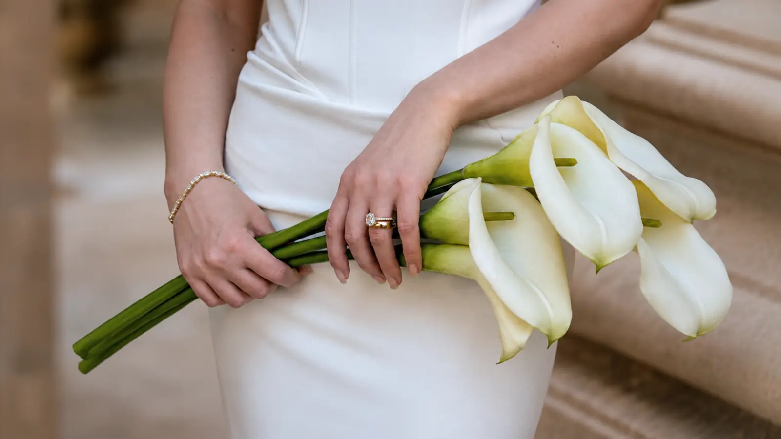 Bride holding a minimalist white calla lily wedding bouquet