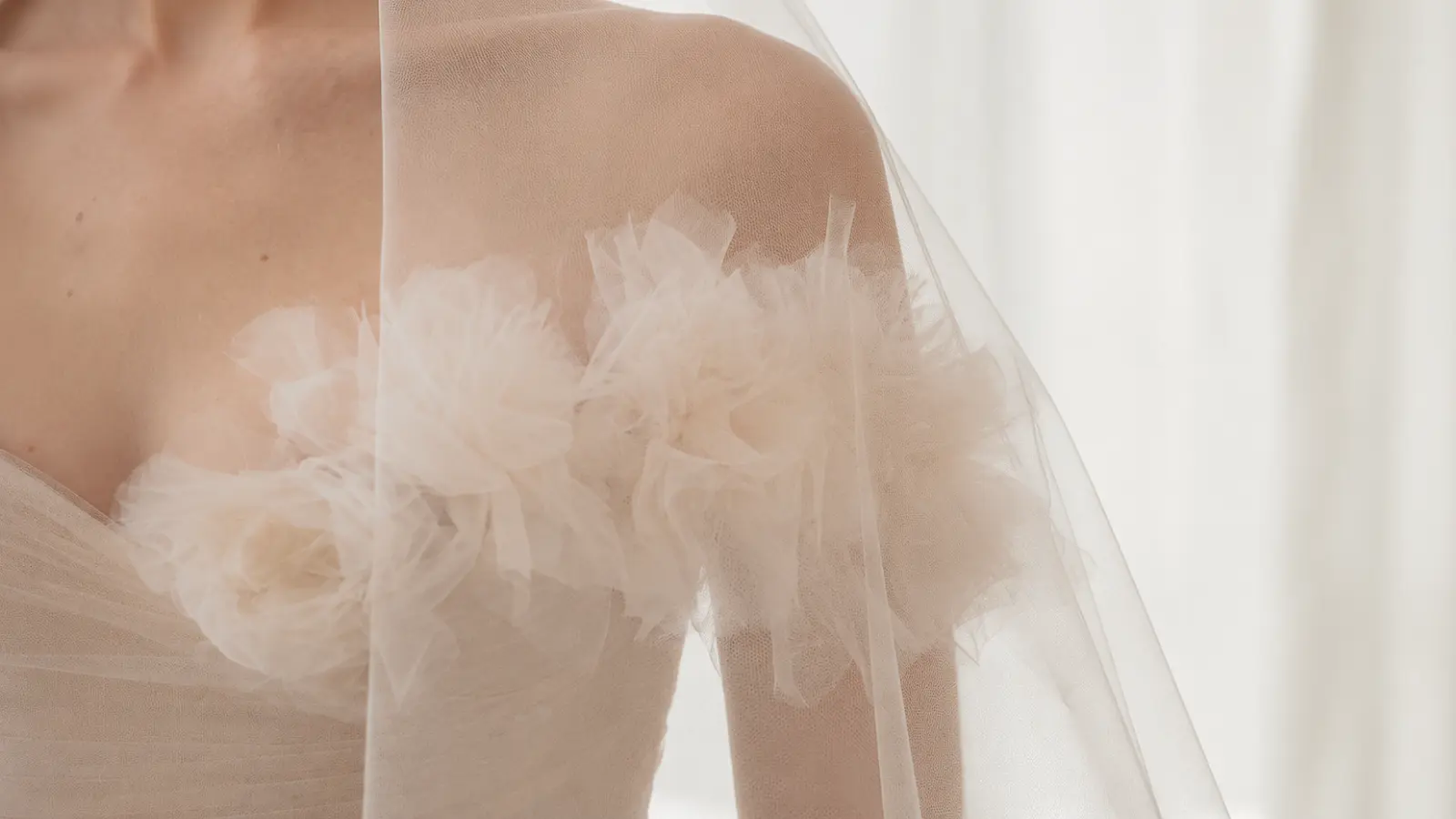 Close-up of a modern minimalist wedding veil made from soft tulle, complementing a contemporary bridal gown with clean lines and timeless elegance