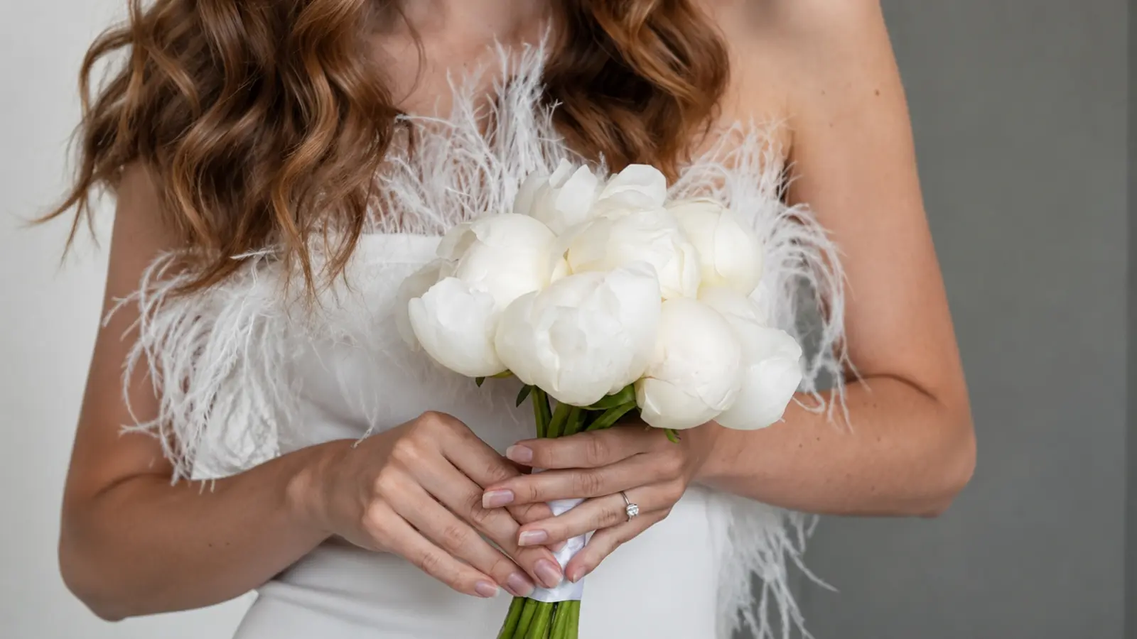 Bride holding a modern white peony wedding bouquet