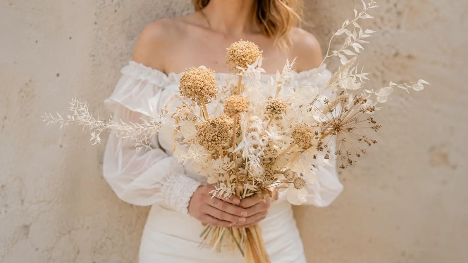 Neutral dried flower wedding bouquet with preserved ivory botanicals sculptural stems and minimalist styling