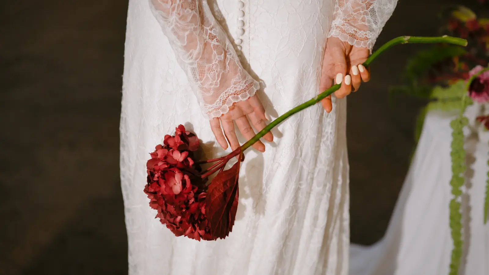 Bride holding a white tulip nosegay bridal bouquet with a satin ribbon handle