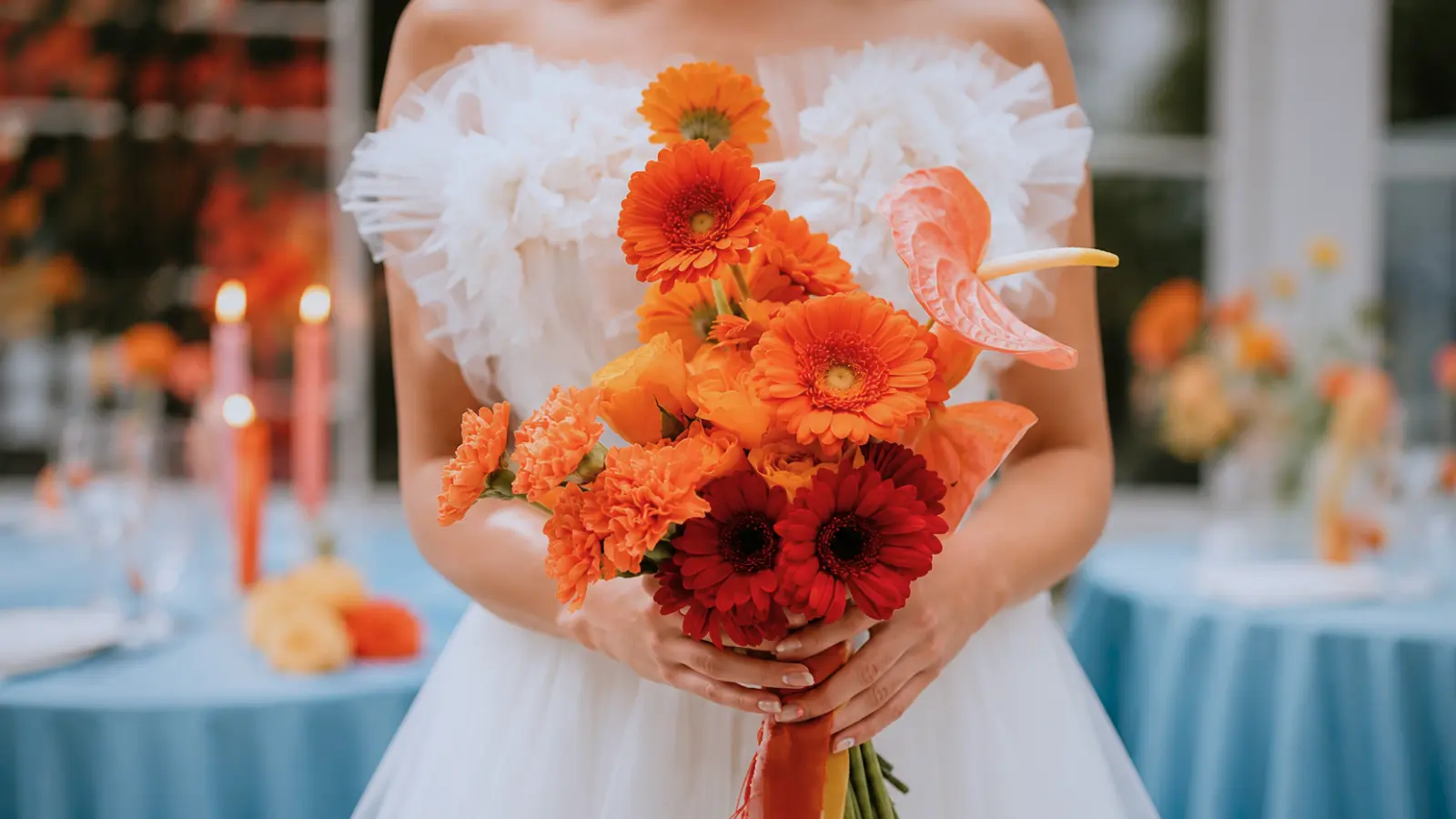 Bride holding an orange gerbera wedding bouquet with anthurium and carnations