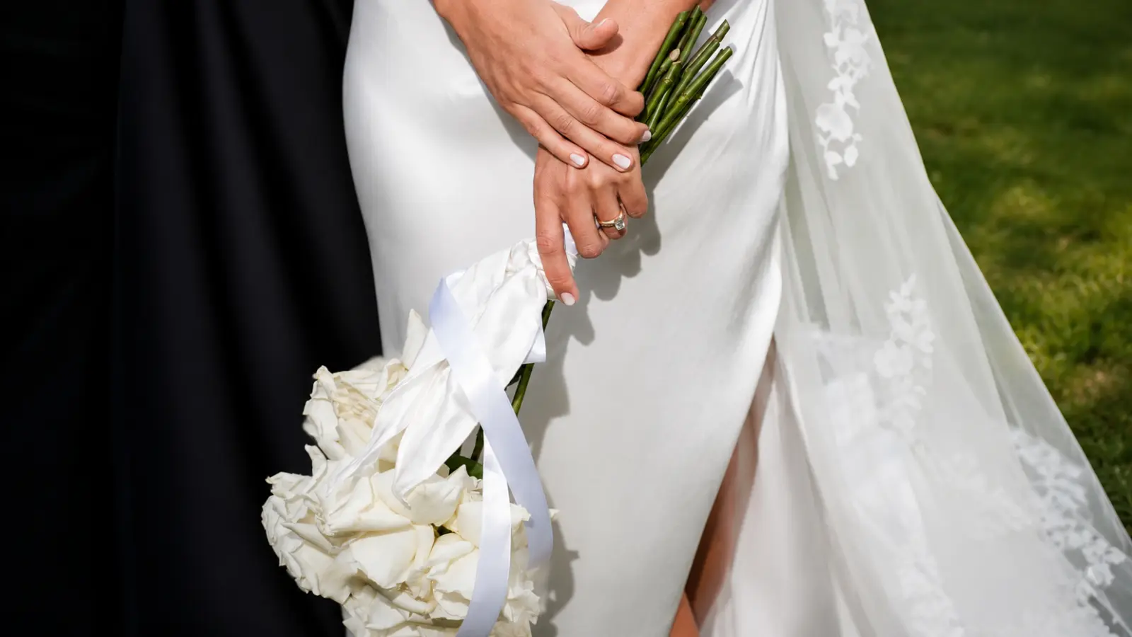 Bride holding a presentation bridal bouquet with a long-stem burgundy hydrangea