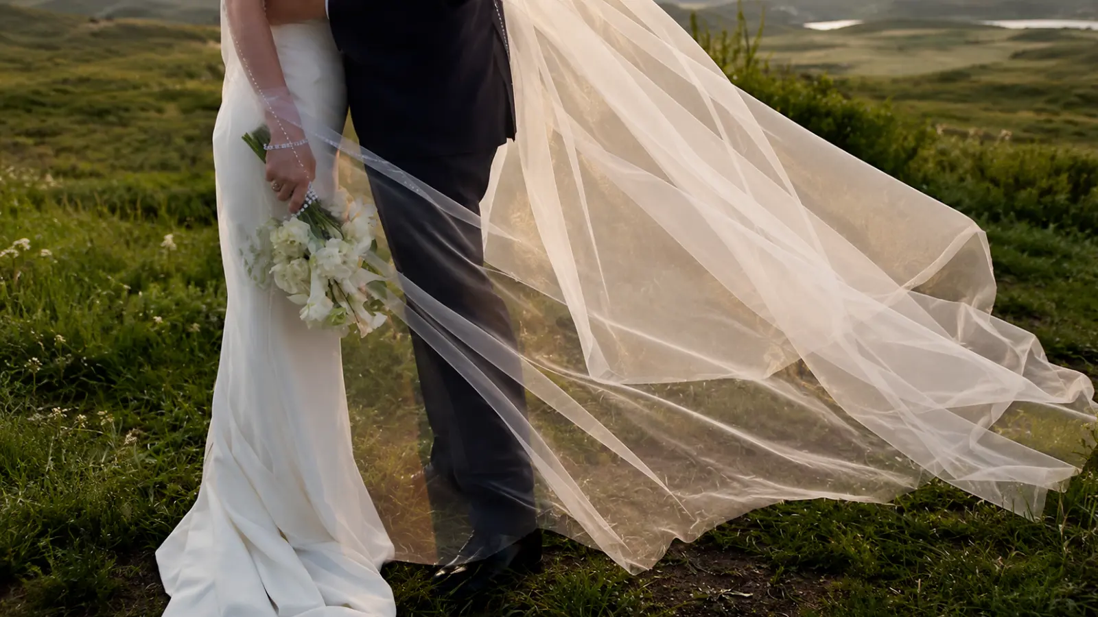 Bride wearing a royal cathedral wedding veil with an extra-long flowing train, demonstrating the most dramatic wedding veil length available