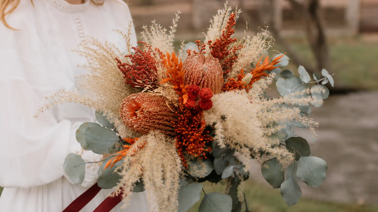Rustic dried fall wedding bouquet with pampas grass, preserved flowers, eucalyptus and natural textures