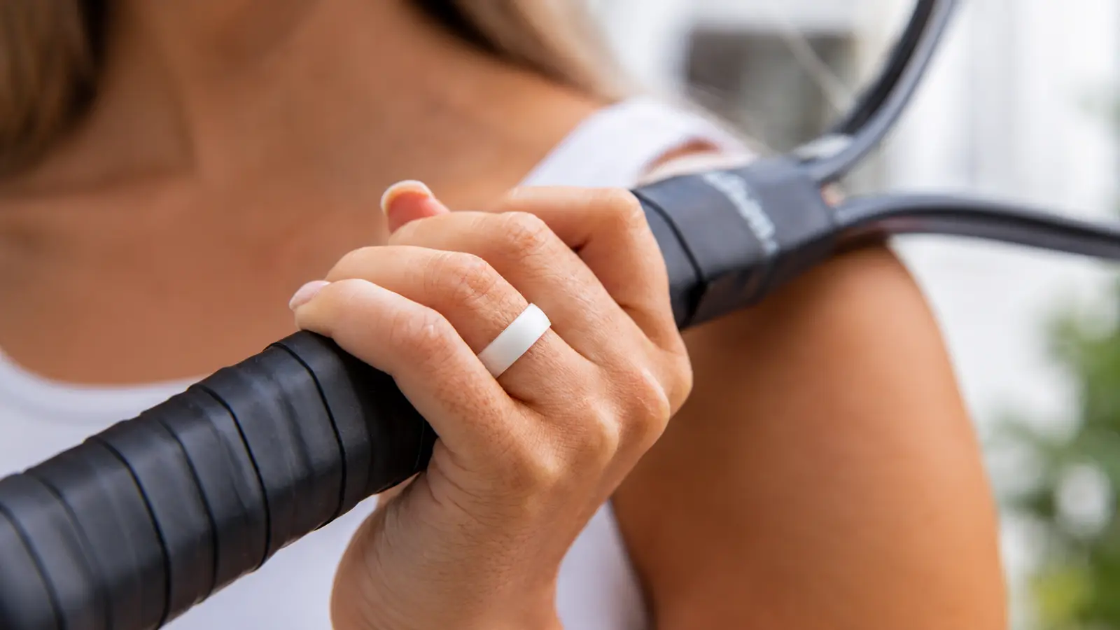 A white silicone wedding ring worn while exercising as a practical alternative to metal rings