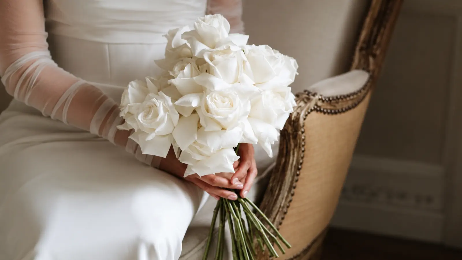 Bride holding a simple white rose wedding bouquet