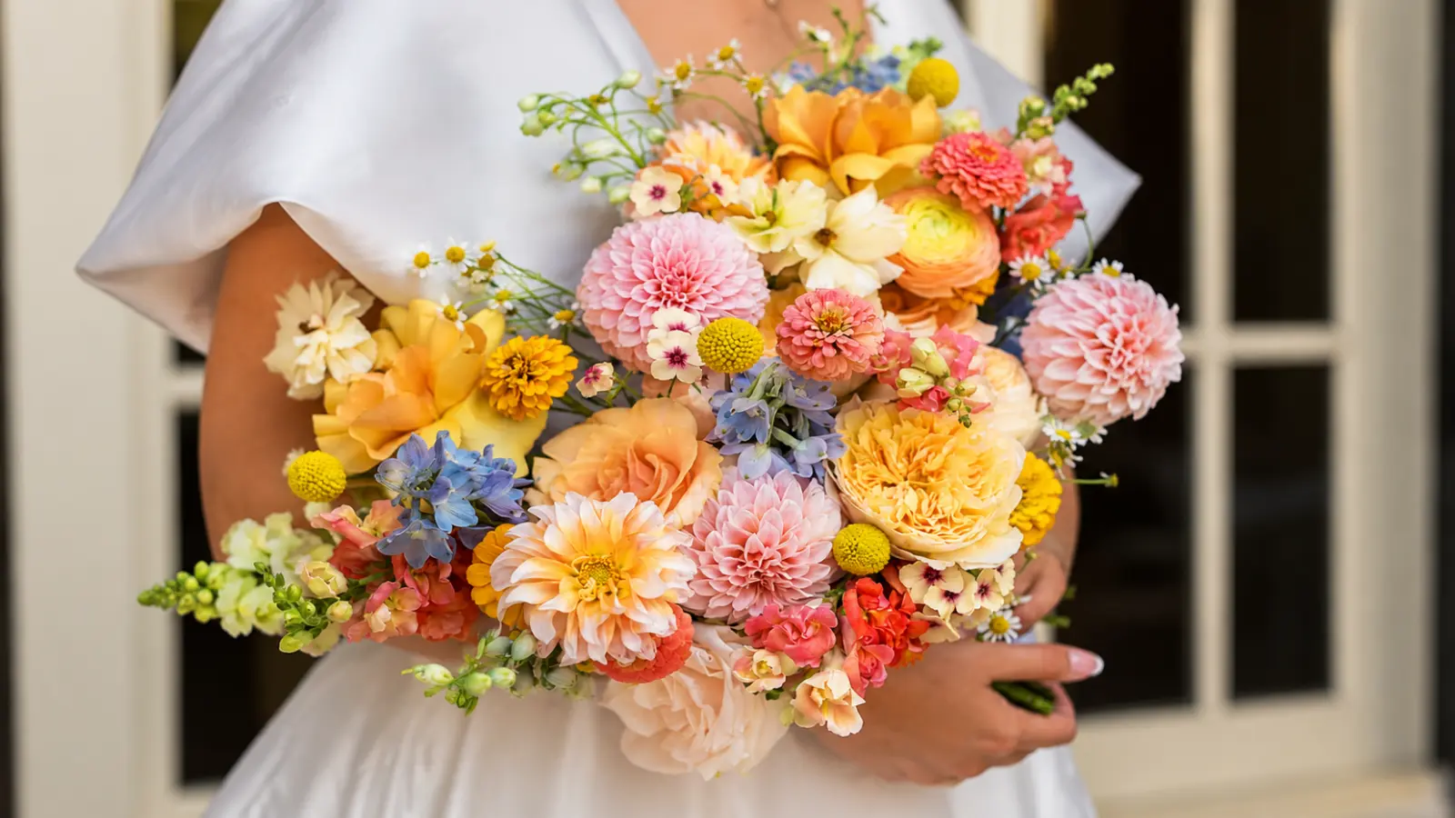 Bride holding a summer wedding bouquet with dahlias, garden roses and seasonal flowers Wedding Bouquet Flowers