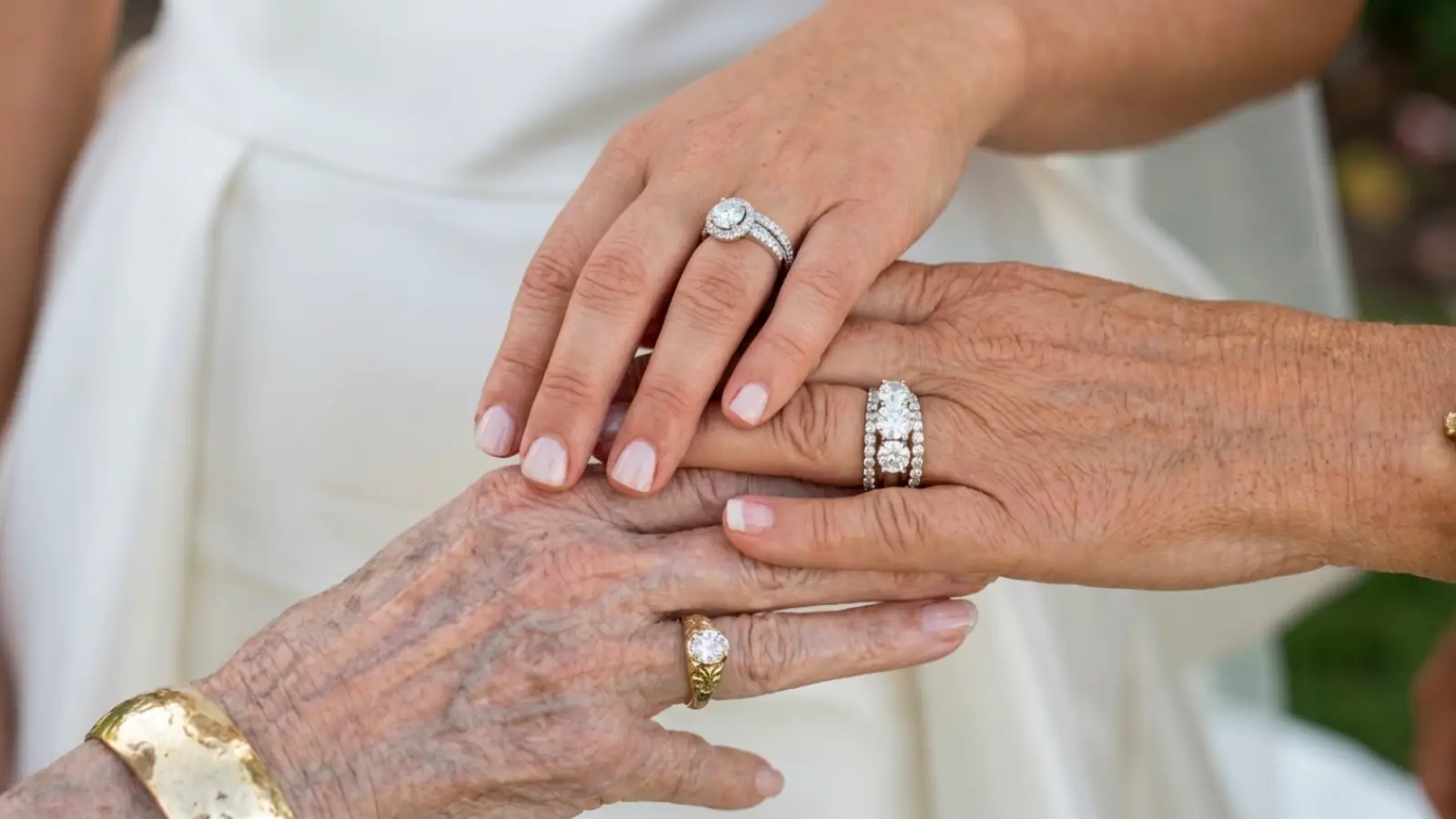 Three generations of women comparing anniversary rings, engagement rings, and wedding bands, celebrating family traditions, enduring love, meaningful milestones, and lifelong commitment across generations