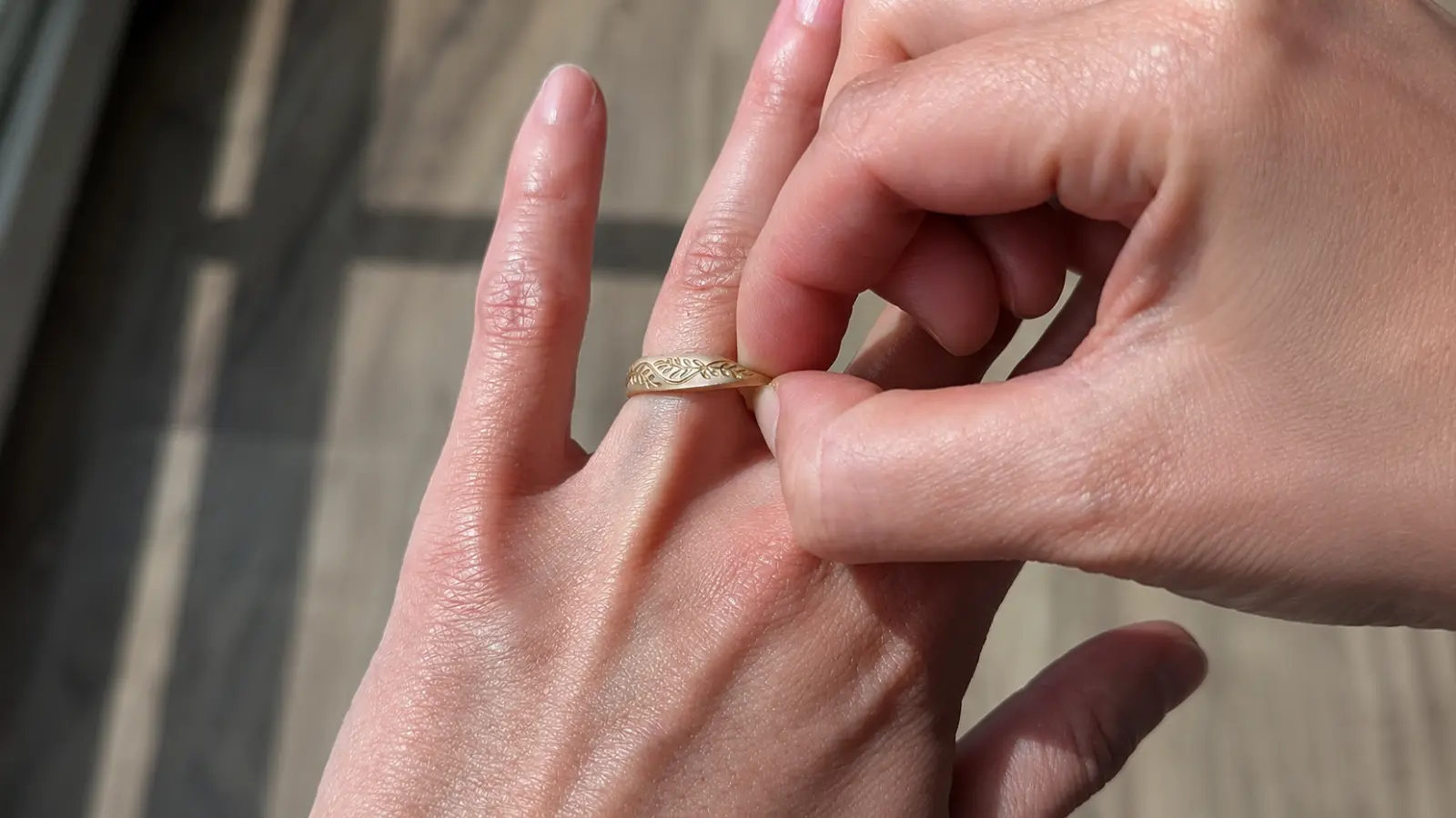 A person putting on a decorative travel wedding ring before leaving for a trip