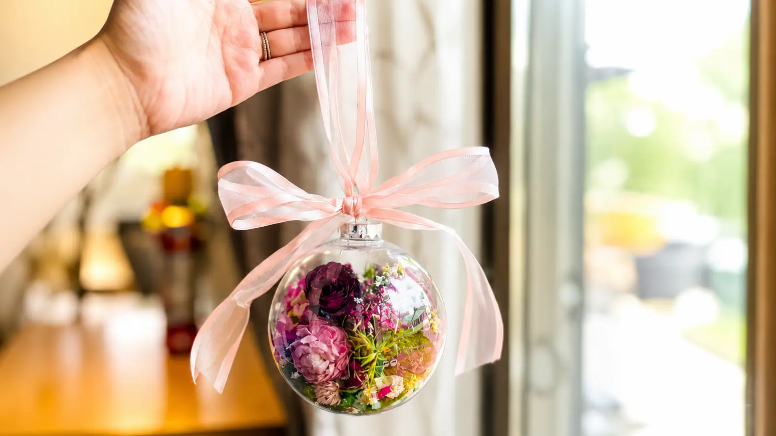 Wedding bouquet flowers preserved inside a decorative glass ornament