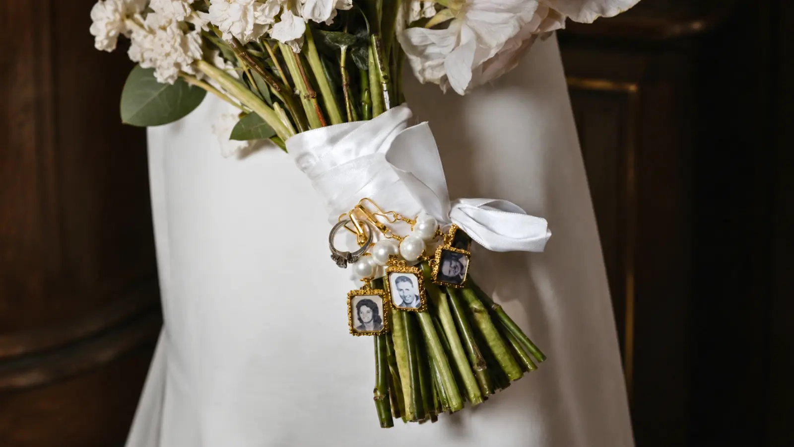 Wedding bouquet featuring memorial photo charms attached to the ribbon wrap