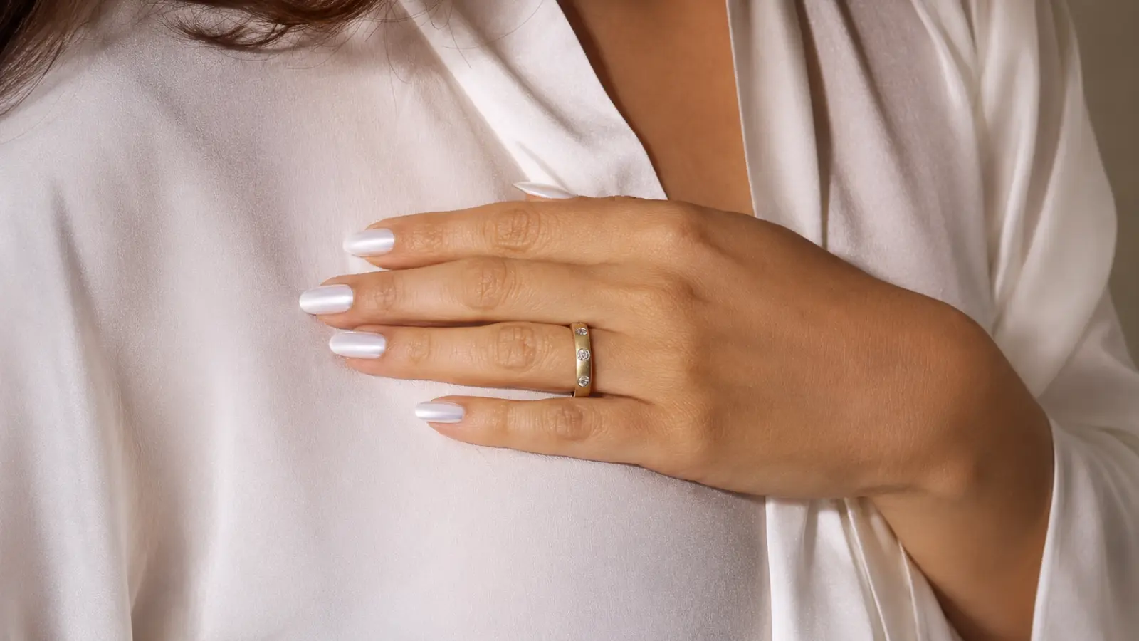 Yellow gold wedding band with bezel-set diamonds