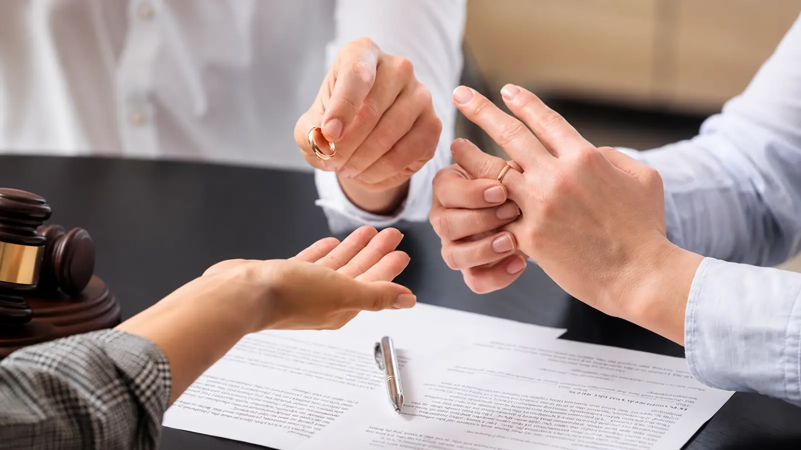 Couple removing wedding rings over legal documents, illustrating annulment vs divorce, legal grounds, marital validity and key differences Annulment vs Divorce: Legal Grounds, Validity and Key Differences