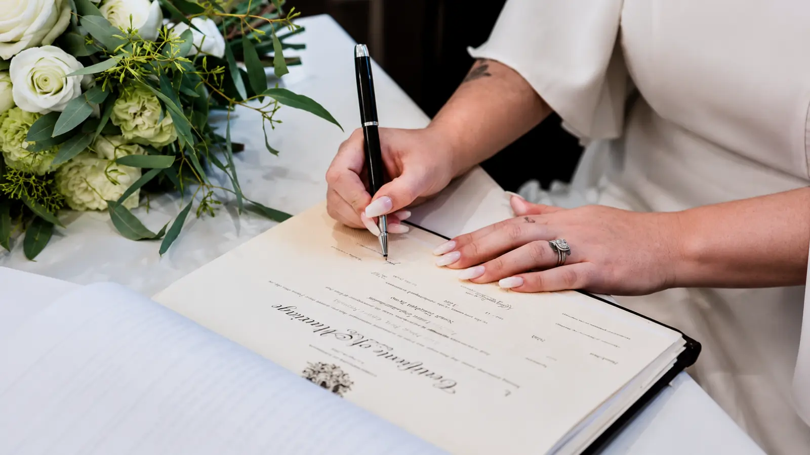 Person signing civil union documents during a formal ceremony, representing registration, legal rights and differences from marriage Civil Union: Meaning, Rights, Registration and Differences From Marriage