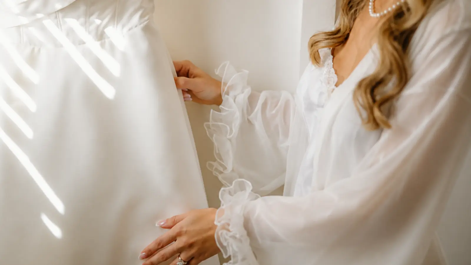 Bride checking her wedding dress as part of the final preparations on the day before her wedding Day Before Wedding Checklist: Keep the Final 24 Hours Simple