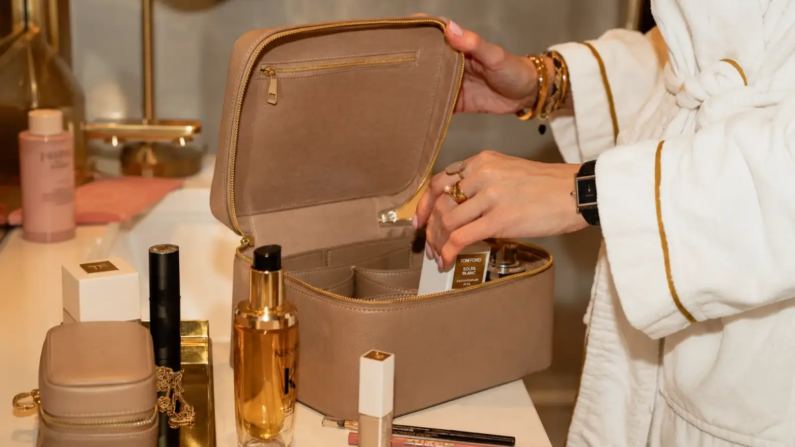 Bride packing beauty products and personal essentials into a case on the day before her wedding