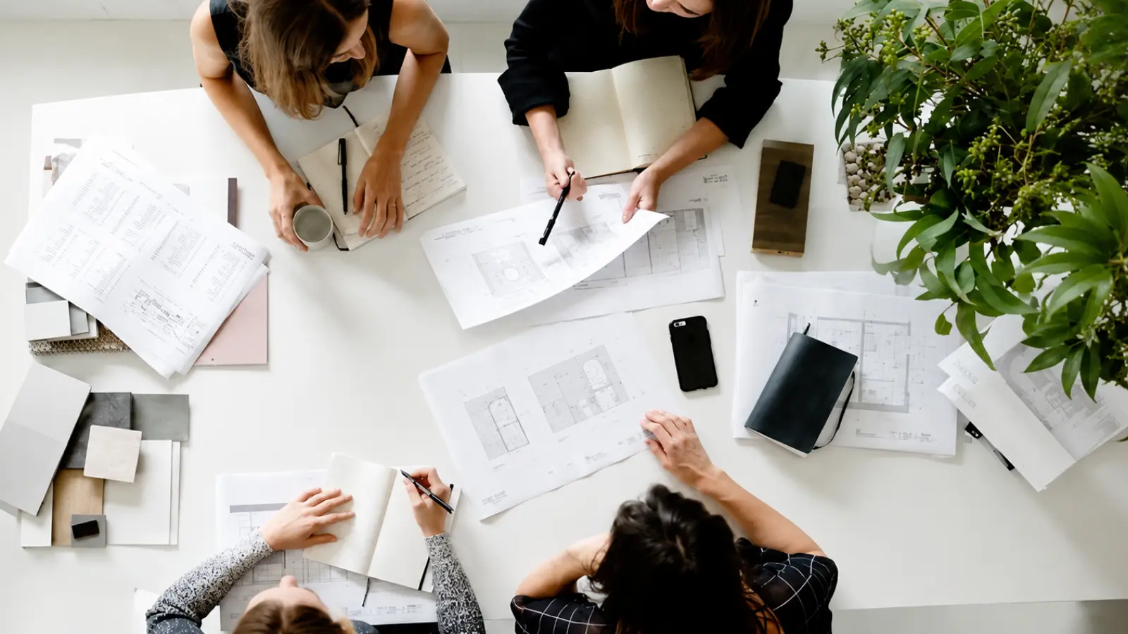 Wedding planning team reviewing plans together while delegating tasks and responsibilities How to Delegate Wedding Planning Tasks That Actually Stay Delegated