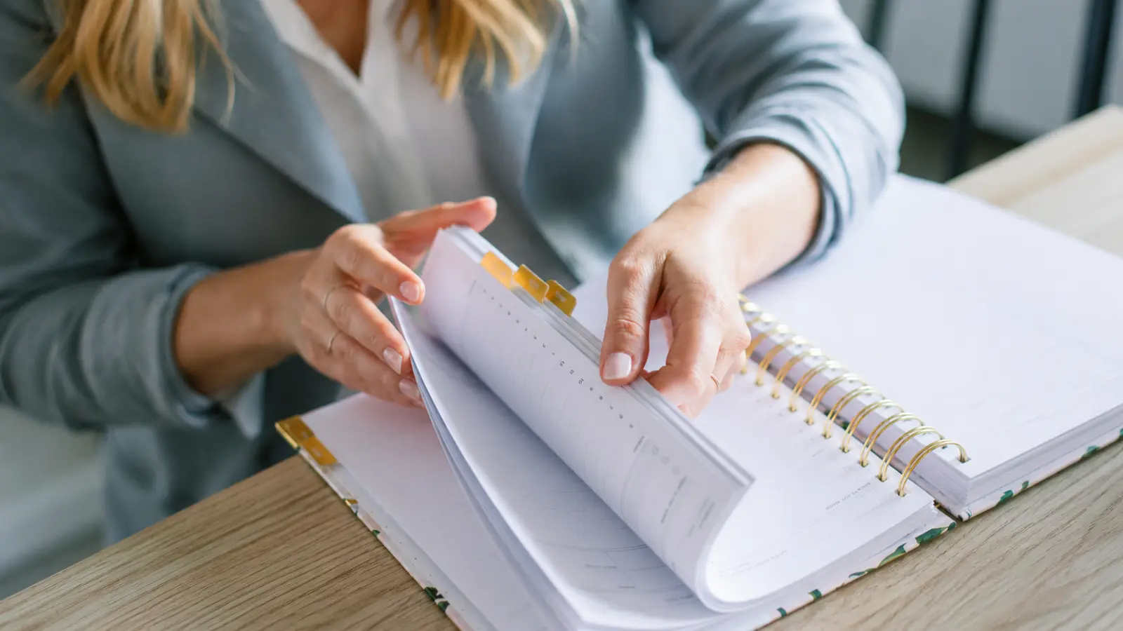 Digital vs Paper Wedding Planner comparison represented by a woman reviewing an organized paper planner while deciding which wedding planning system works better Digital vs Paper Wedding Planner: Which System Works Better?