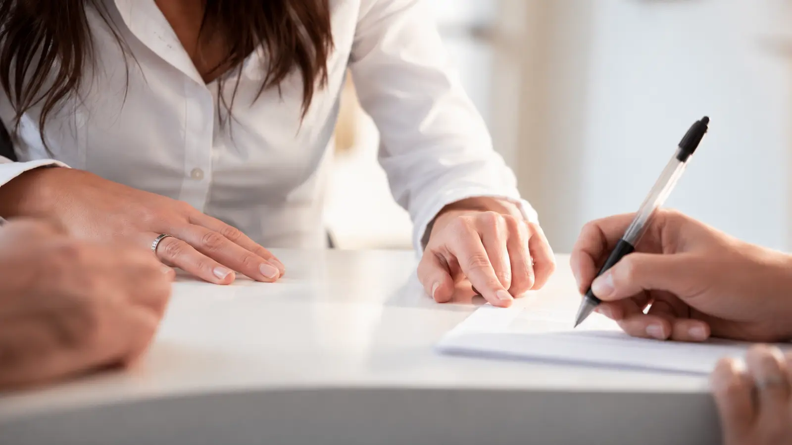 Couple reviewing and signing legal documents together as part of the domestic partnership registration process Domestic Partnership: Meaning, Registration, Benefits and Legal Limits