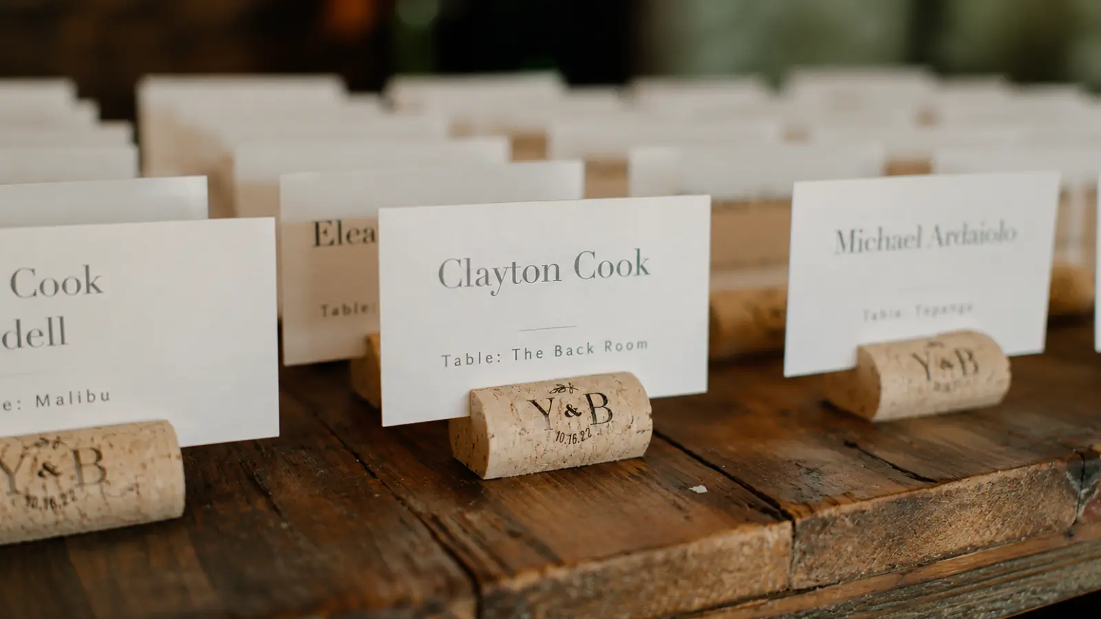 Escort Cards vs Place Cards vs Seating Charts represented by personalized wedding escort cards displaying guest names and assigned reception tables Escort Cards vs Place Cards vs Seating Charts: What’s the Difference?
