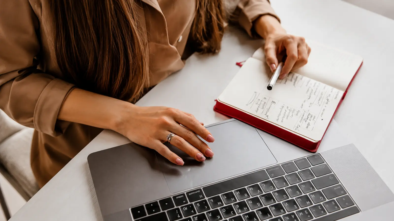 How Much Does a Wedding Cost? Bride-to-be reviewing wedding planning notes and using a laptop to research average wedding costs, expenses and the main cost drivers that shape a wedding budget How Much Does a Wedding Cost? Average Costs and Cost Drivers
