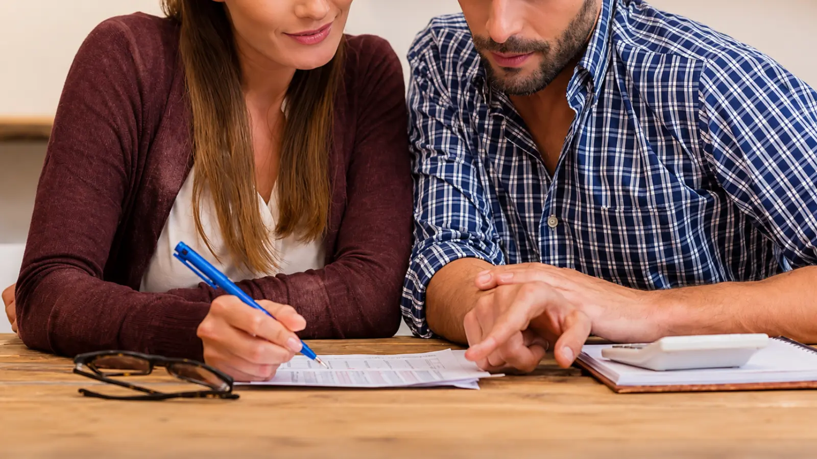 How to Plan a Wedding on a Budget with a couple reviewing expenses and making spending decisions together to save money while protecting the wedding details and priorities that matter most How to Plan a Wedding on a Budget Without Cutting What Matters