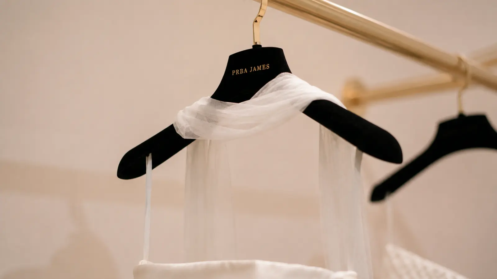 Tulle wedding veil carefully draped over a padded hanger for proper storage before the wedding while helping prevent wrinkles and fabric damage How to Steam and Store a Wedding Veil