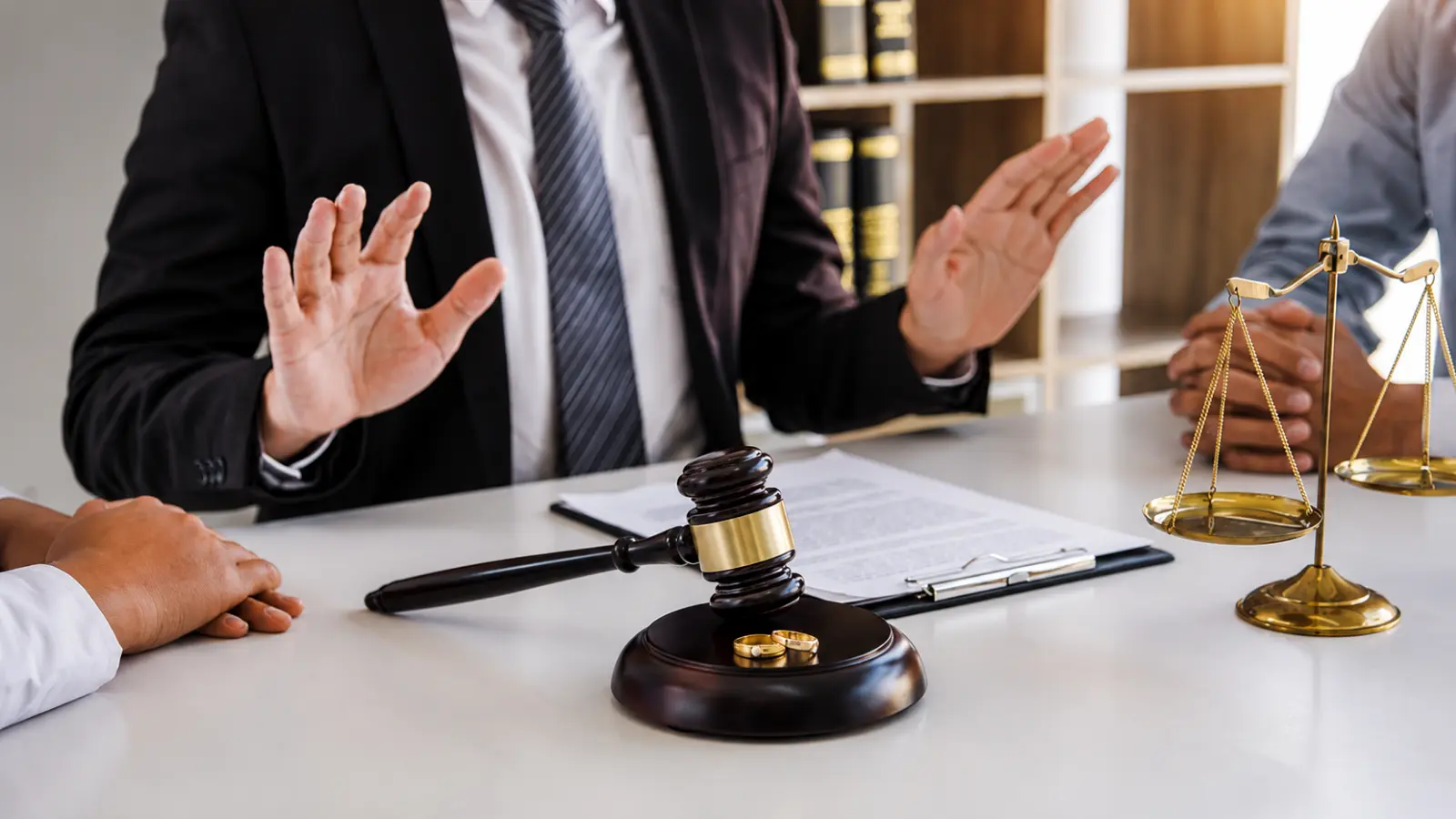 Attorney discussing legal separation and divorce with wedding rings, documents, gavel and scales, illustrating marital status, rights and key differences Legal Separation vs Divorce: Marital Status, Rights and Key Differences