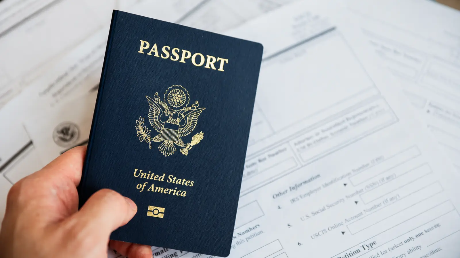 Passport with travel documents illustrating the paperwork and travel timing considerations for a passport name change after marriage Passport Name Change After Marriage: Forms, Documents and Travel Timing