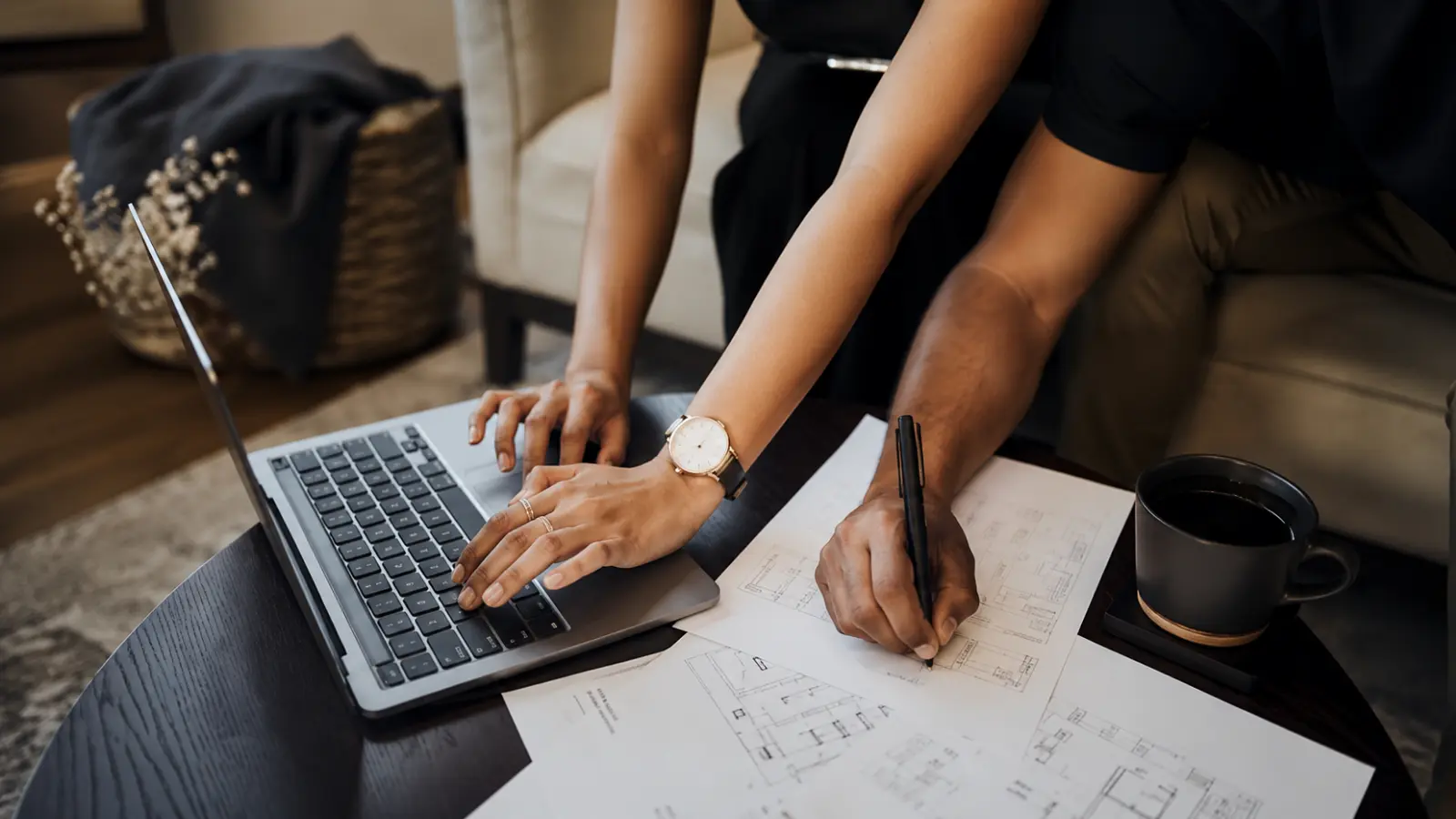 Couple planning their wedding together with a laptop and documents while sharing responsibilities through an organized system designed to reduce wedding planning stress How to Plan a Wedding Without Stress: A Practical System