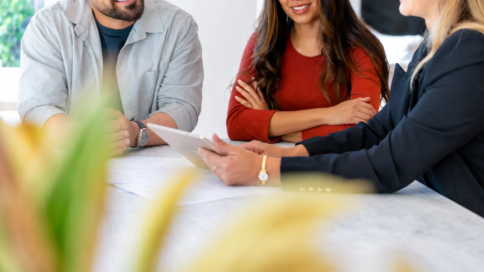 Questions to Ask Wedding Vendors as an engaged couple meets with a professional to discuss details before making a booking decision Questions to Ask Wedding Vendors Before You Book