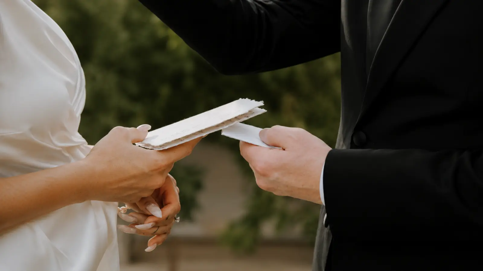 Couple exchanging written vows during a self uniting marriage ceremony, representing how couples can legally marry without a traditional wedding officiant