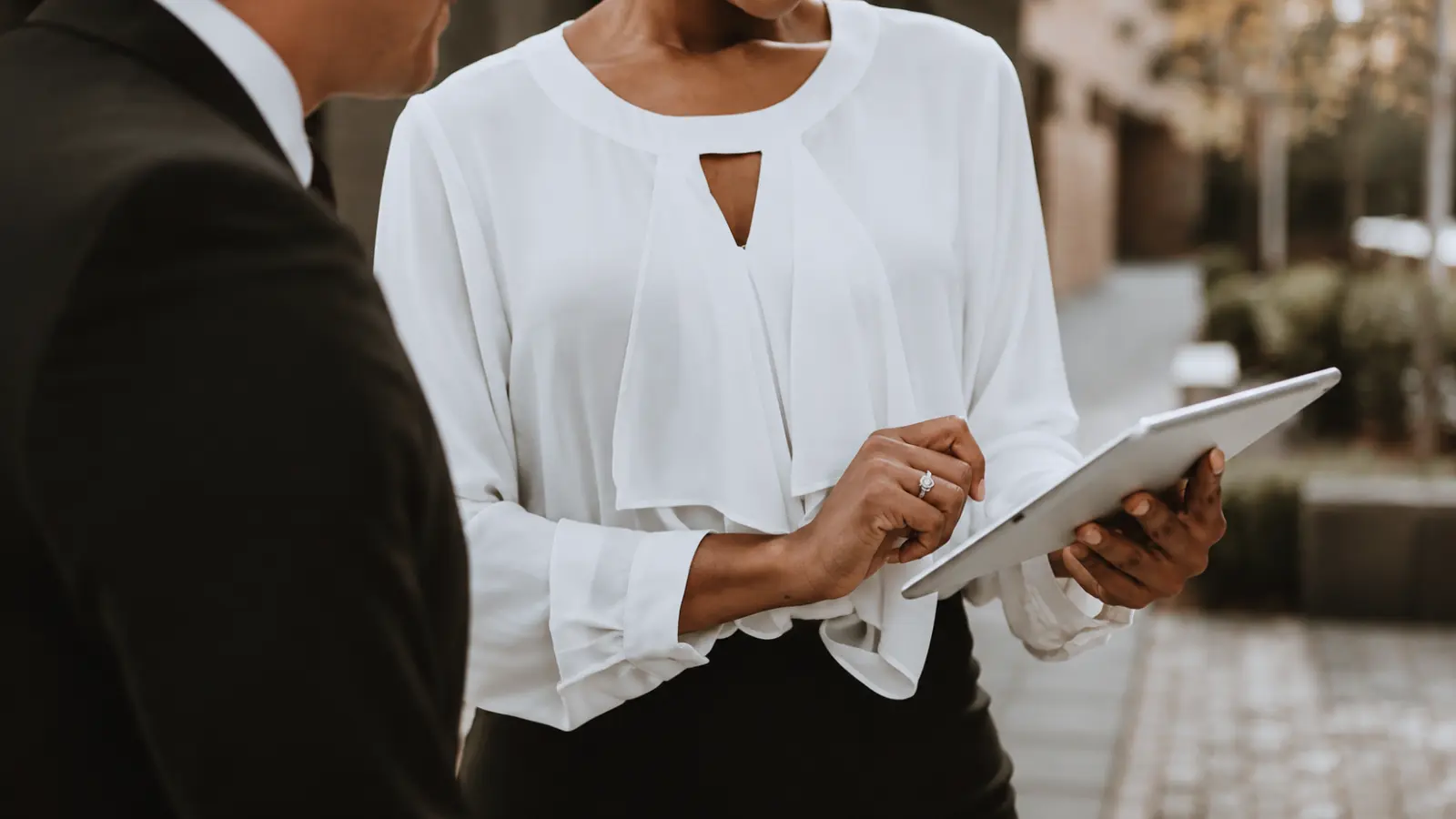 Wedding coordinator reviewing a wedding day timeline on a tablet, confirming schedule details, vendor timing and event logistics to keep the ceremony and reception running smoothly