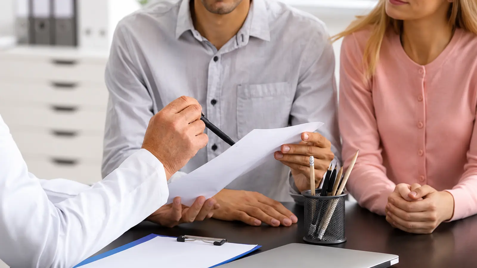 Couple reviews wedding planner costs and service details with a professional during a planning consultation Wedding Planner Cost: How Much Does a Wedding Planner Really Cost?