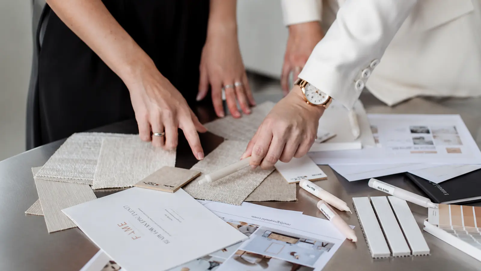 Couple reviewing wedding details, samples and planning documents while working through their wedding planning checklist