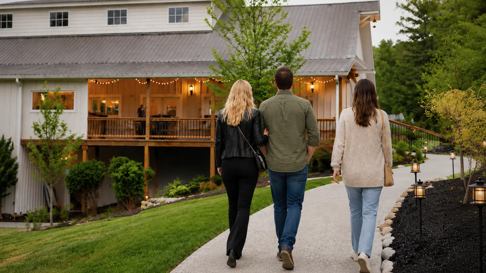 Engaged couple walking with a wedding coordinator while touring a potential wedding venue and evaluating the property for their upcoming celebration