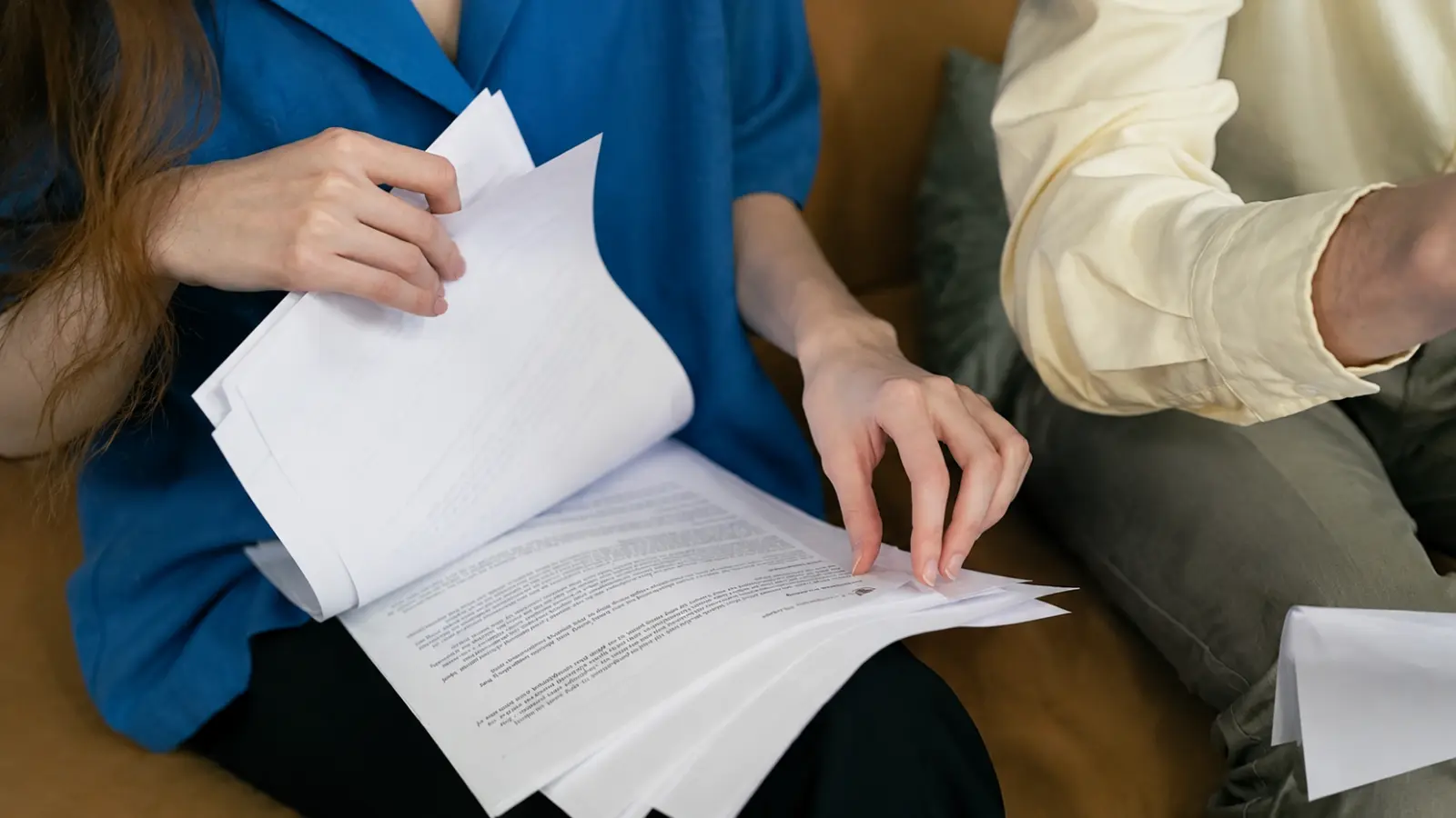 Couple reviewing wedding documents and contract details together to avoid common wedding planning mistakes