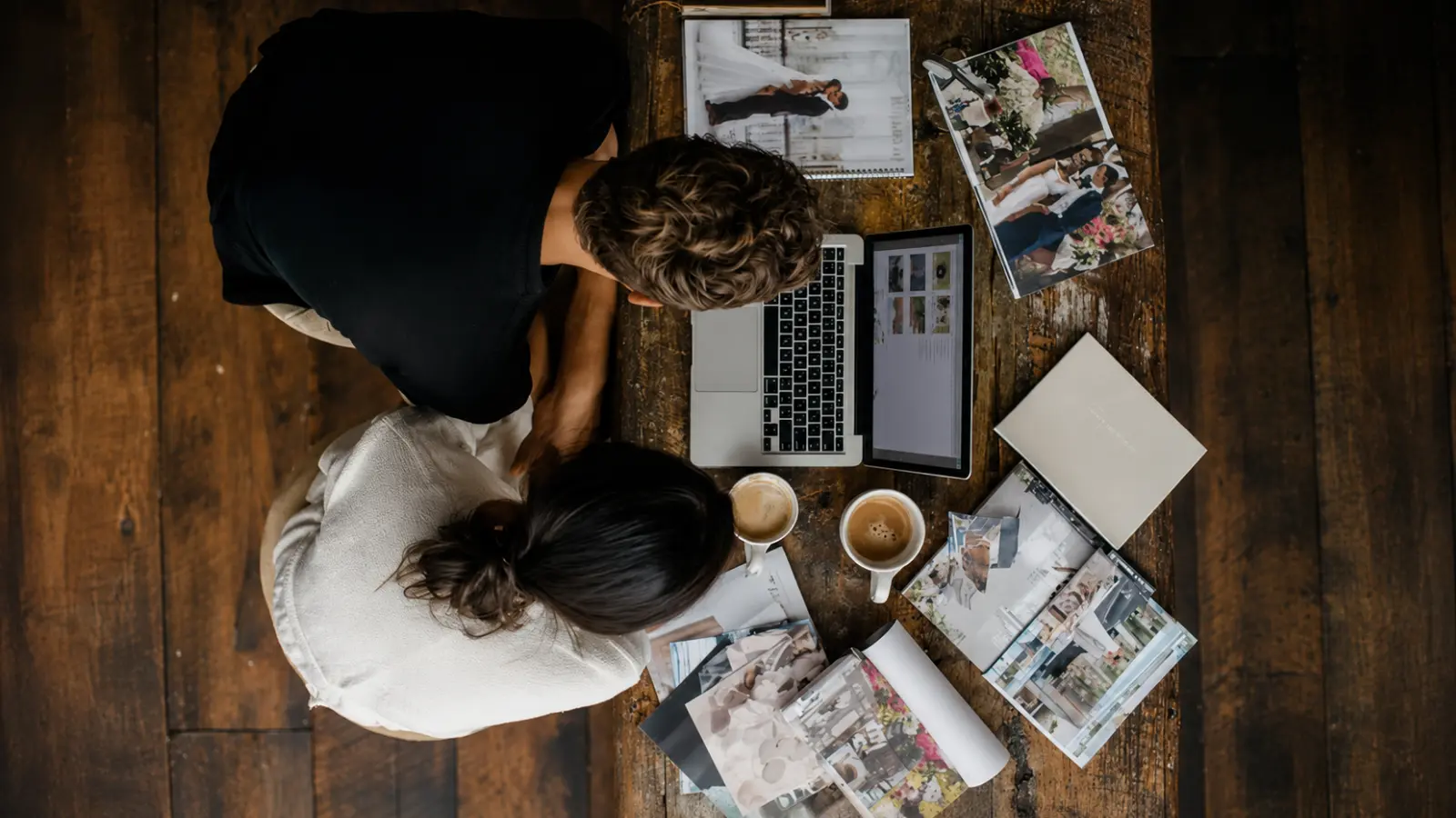 Couple reviewing wedding inspiration together while deciding their most important wedding planning priorities Wedding Planning Priorities: Decide What Matters Most