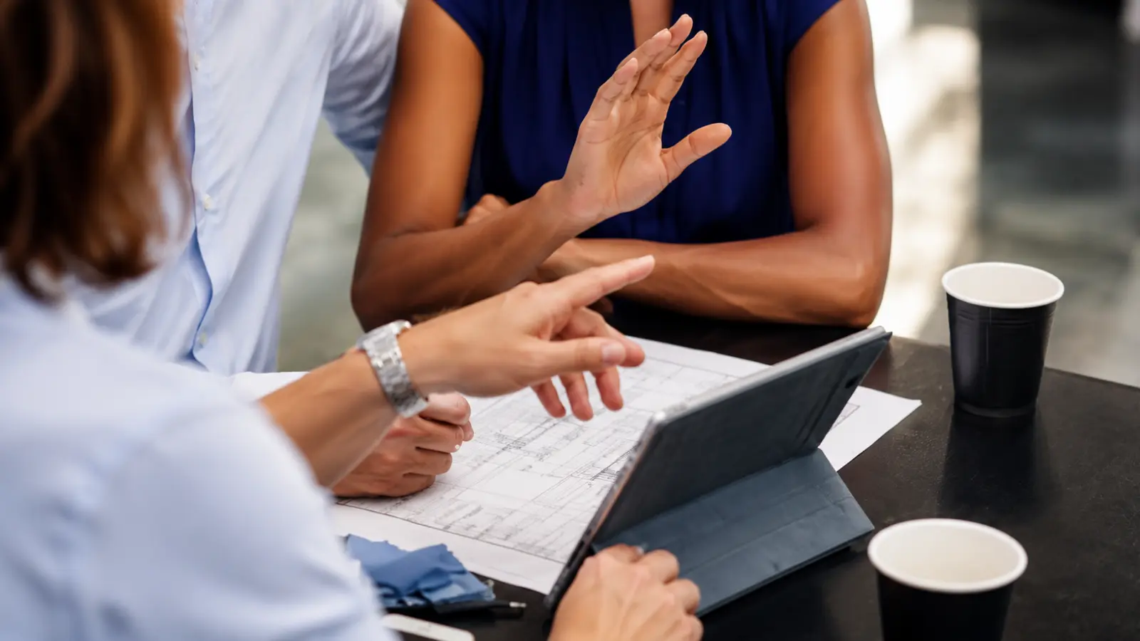 Couple reviews plans with a professional while discussing full-service, partial planning, coordination and other wedding planning services Wedding Planning Services: Full-Service, Partial, Coordination and More
