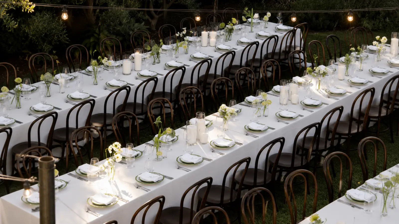 Wedding Seating Chart represented by organized outdoor reception tables with assigned place settings and chairs arranged for guests