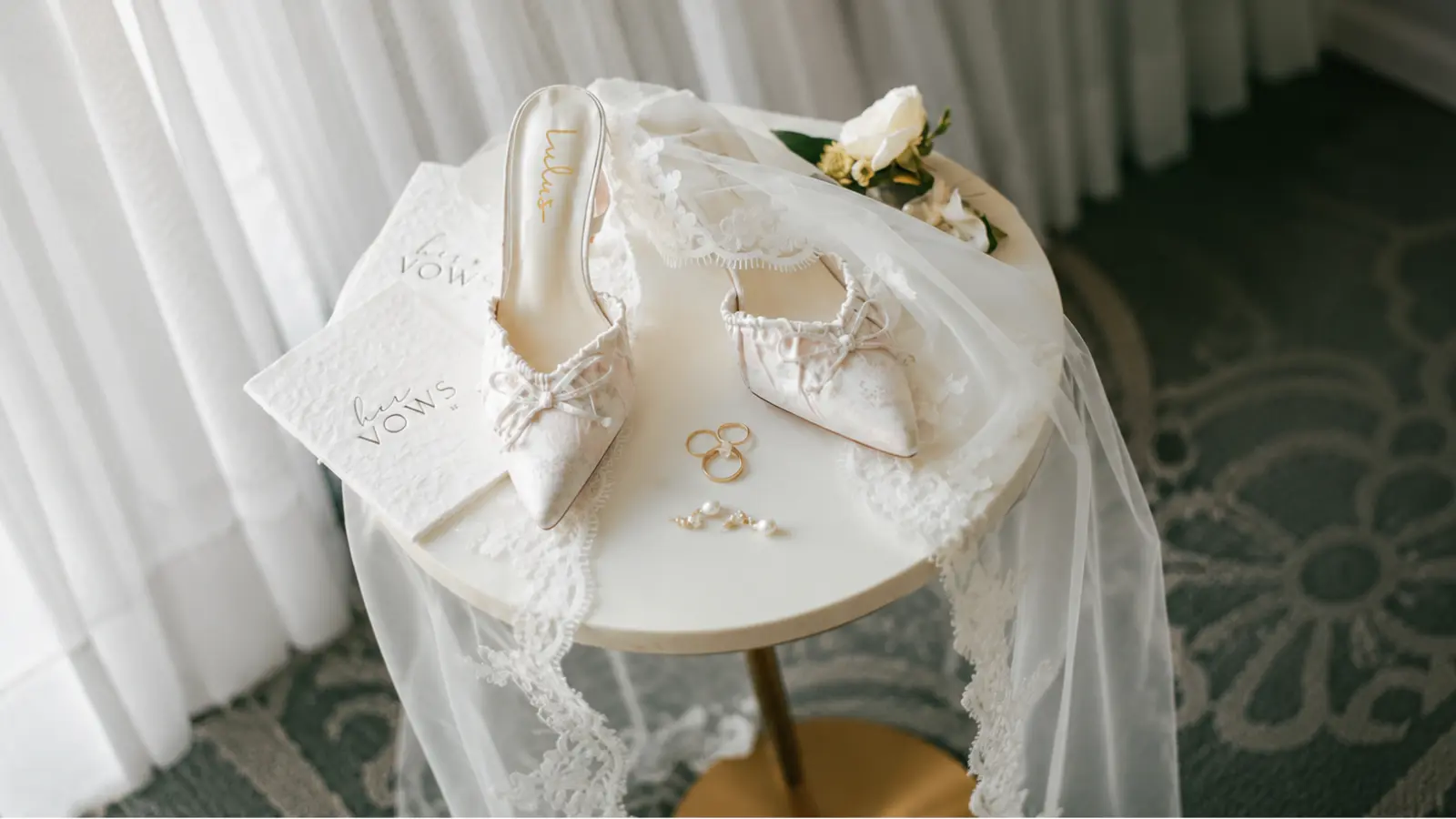 Wedding veil displayed with bridal shoes, rings and wedding accessories as a coordinated keepsake collection to preserve after the wedding