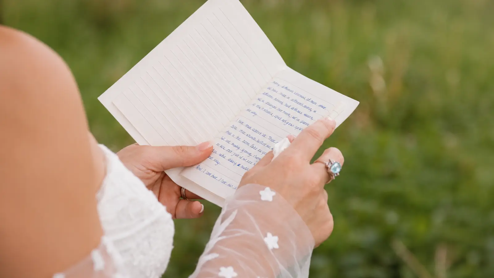 Bride reading handwritten wedding vows for him before the ceremony, preparing personal promises and meaningful words to share with her groom