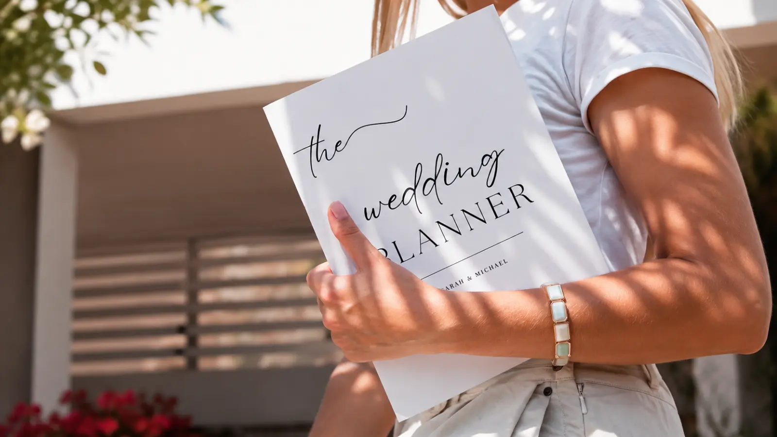 Bride holding a wedding planner while organizing final details during the last week before her wedding Wedding Week Checklist