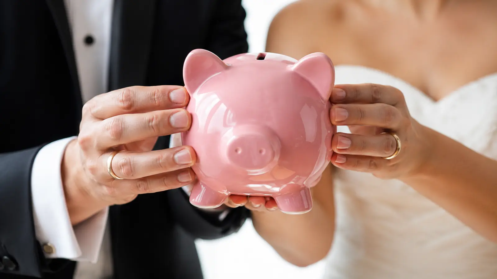 Who Pays for a Wedding? Bride and groom holding a piggy bank together, representing how couples and families can contribute, share expenses and split wedding costs using modern arrangements Who Pays for a Wedding? Modern Ways to Split Costs